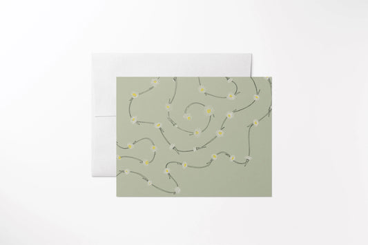 Blank notecard with a hand-drawn multi-colored daisy chain. Printed on 100% recycled, uncoated paper, green, with a matching white envelope.