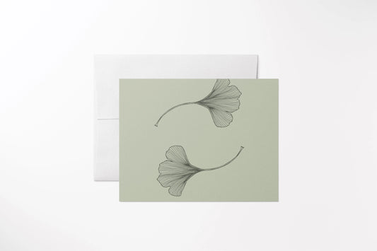 Blank notecard with a hand-drawn gingko leaf pattern. Printed on 100% recycled, uncoated paper, with a matching white envelope.